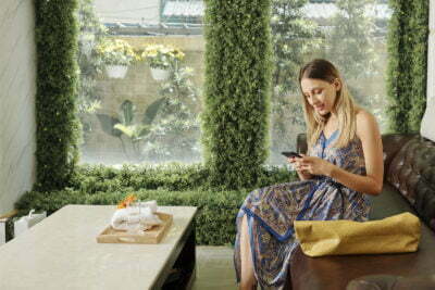 a person sitting on a couch looking at a phone