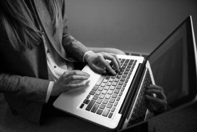 a person typing on a laptop