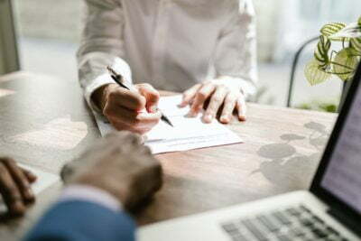 a person writing on a paper