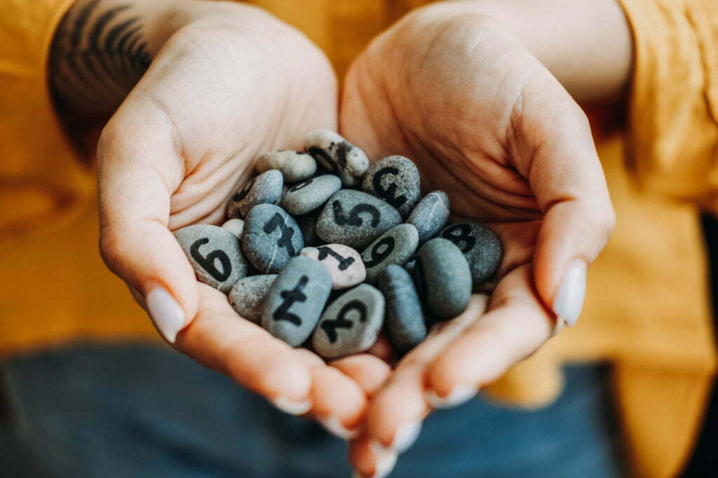 a person holding a pile of rocks