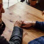 a man and a woman looking at a wooden table