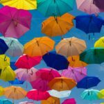 a group of umbrellas are in the air
