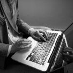 a person typing on a laptop