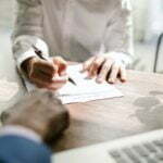 a person writing on a paper