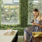 a person sitting on a couch looking at a phone