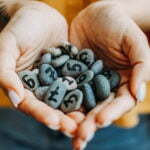 a person holding a pile of rocks