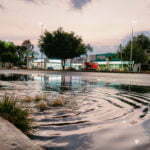 Water gushing out of road storm drain