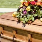 Lovely floral arrangement on wood casket.